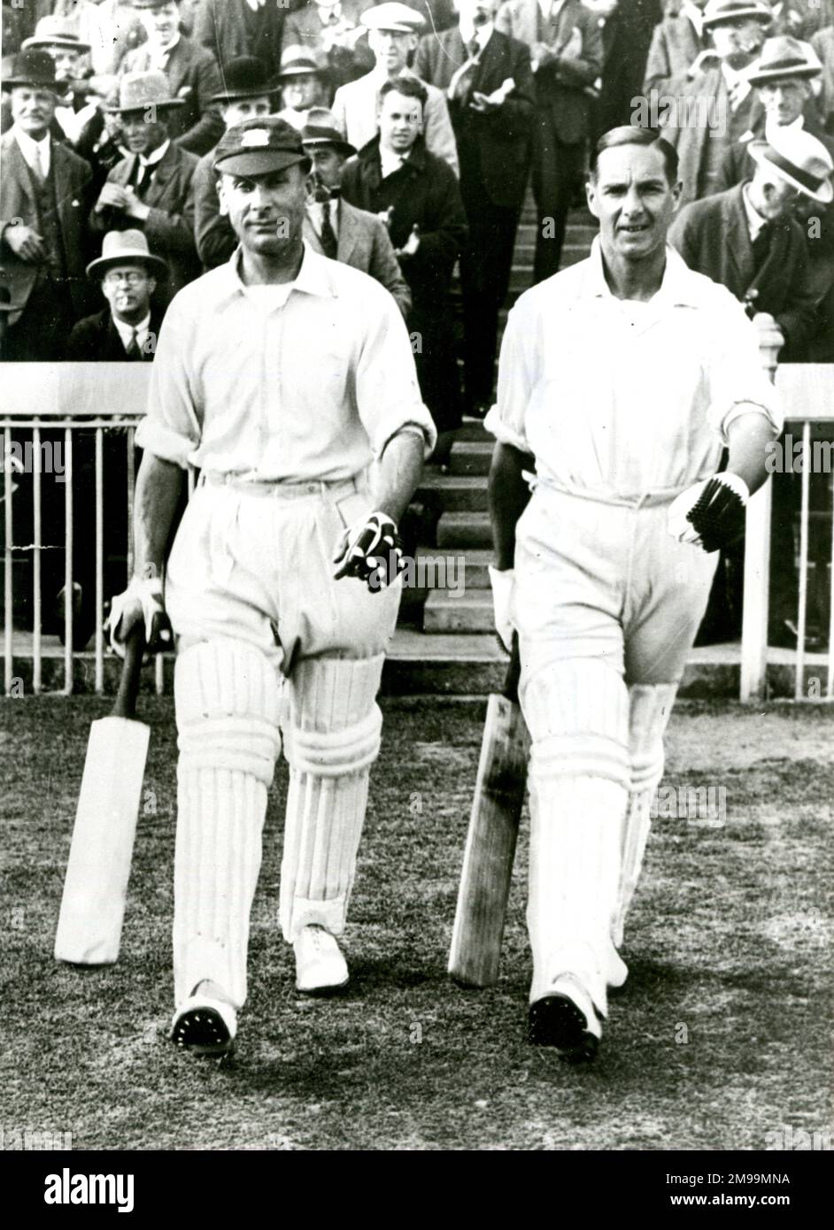 Jack Hobbs and Herbert Sutcliffe, cricketers, coming out to bat.  They formed an opening partnership for the England team between 1924 and 1930. Stock Photo