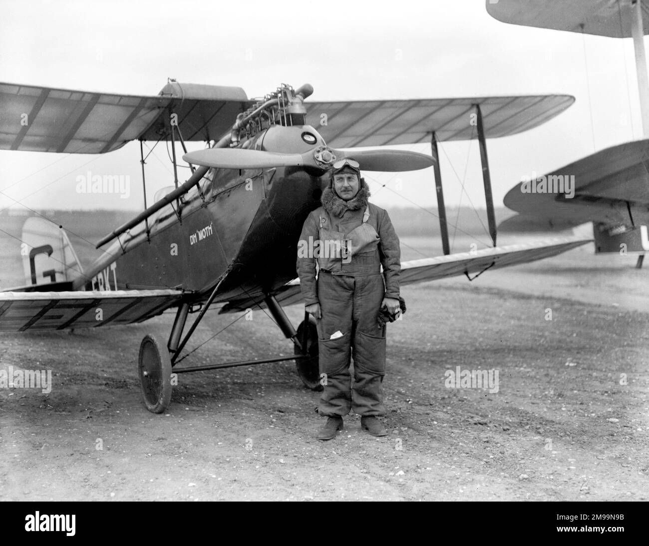 Sir Alan John Cobham (1894û1973) - English aviation pioneer standing in front of  his de Havilland DH.60 Moth G-EBKT, a light-weight, two-place, single-engine, single-bay British two-seat touring and training biplane aircraft. A prototype which Cobham flew from Croydon to Zurich and back in 14 hours, 49 minutes on 29th May 1925 (after which this photograph was likely taken). Cobham also flew the Moth in The Kings Cup Air Race, though weather forced him to land short of the finish. It placed second in a follow-up race. The aircraft ended its days in a crash at Stanmore on 21 August 1927. Stock Photo