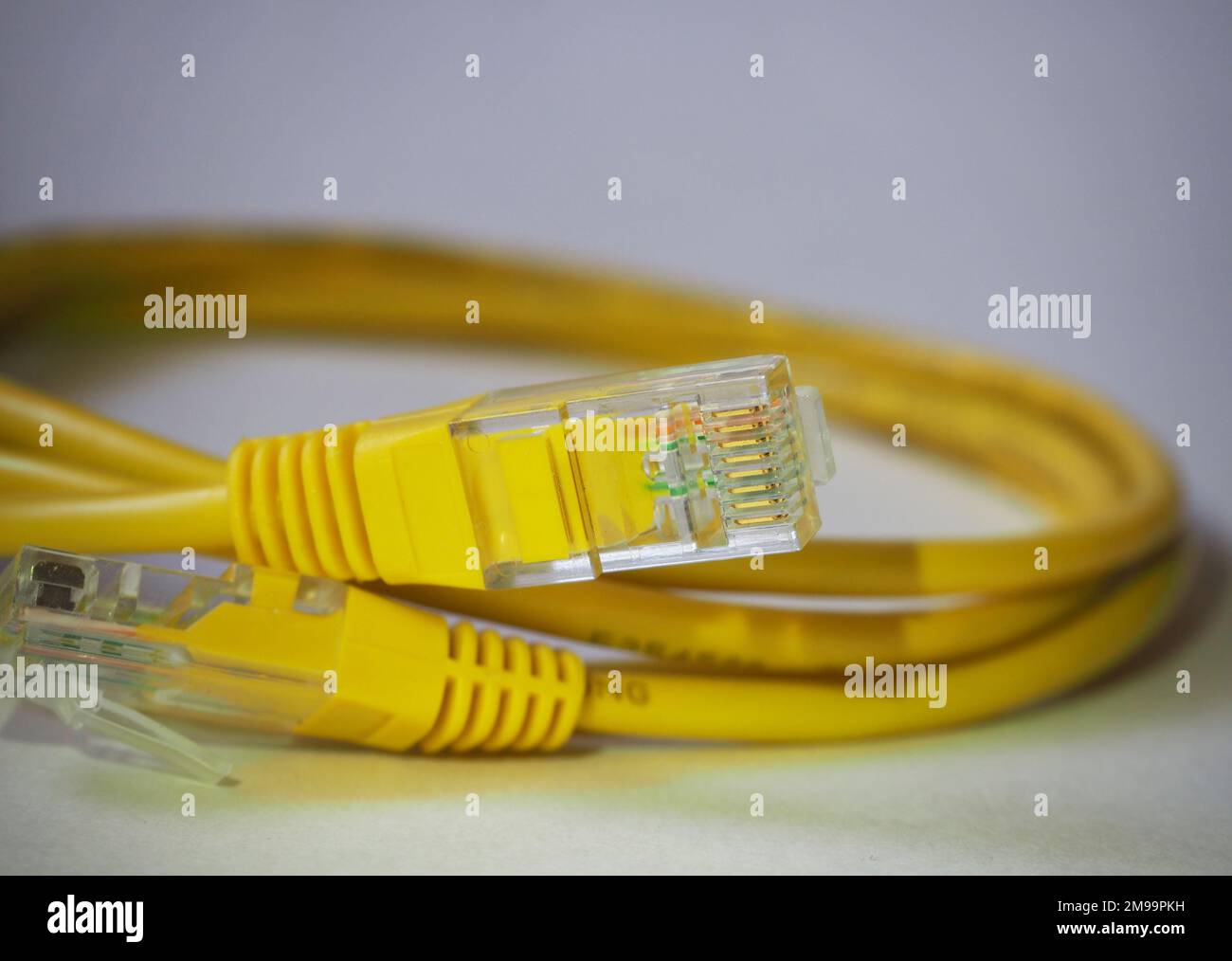 Yellow erhernet cable. Comminications, network background. Internet connecting cable. Stock Photo