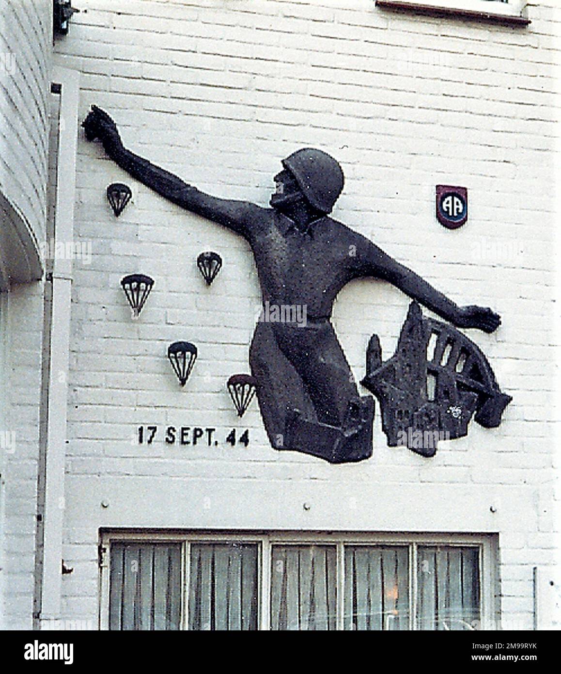 During Operation Market Garden in September 1944 this area was taken by the 508th Parachute Infantry Regiment of the US 82nd Airborne Division. The figure on the wall is a Memorial to that Division. The hotel had been used for almost four years by the Germans as an HQ and then as a parachute training school. They also used the Klooster Nebo, the large Catholic Seminary across the road, both of which were taken over by the advancing Allies' war correspondents and photographers who arrived by glider. Guards Armoured Division Officers moved into the hotel, to be followed by 82nd Airborne staff. Stock Photo