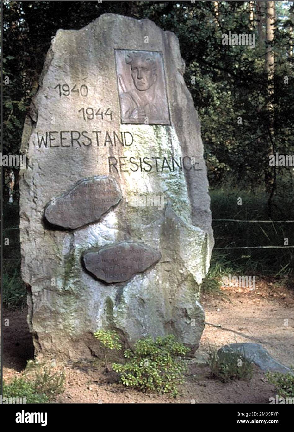 This Memorial in the Hechtel Woods is in a site known as 'The Secret Cemetery' and is signed to the Dunes des Fusilees. The execution site was established by the Germans in May 1942 and they kept detailed records of those shot - names, date and place of birth, offence, date of death etc. It was designated as the place of burial for all those executed in Belgium including many locals. After burial the graves were marked by a numbered pole. The area of the site was guarded by German snipers in towers at each corner. Stock Photo