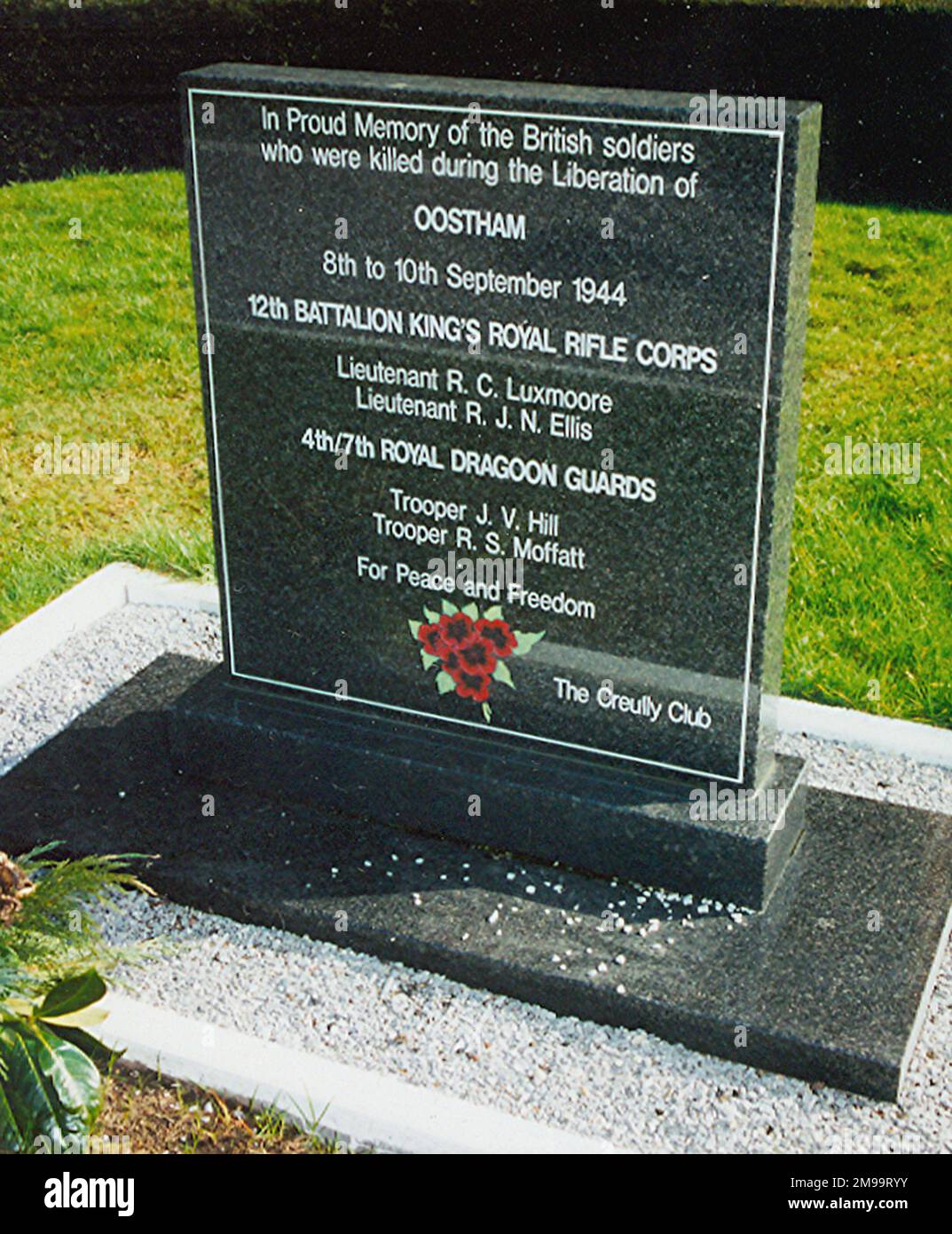 This black polished granite Memorial was raised in September 2000 at the instigation of local historian Carl Reymen, the town council and local history society in co-operation with the regiments concerned in the battle for the village - Oostham. It commemorates the soldiers killed in the figting to liberate Oostham, carries the legend 'For Peace and Freedom', bears an engraved poppy spray andi is signed 'The Creully Club'. The fighting began on the 8th September 1944 as the British advanced northwards beyond the Albert Canal and met the German 3rd Squadron Panzerjager Abteilung. By nightfall Stock Photo
