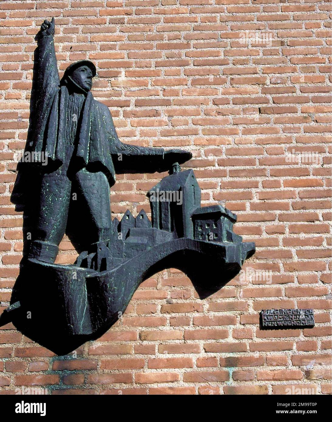 This bas-relief by Jan Kettering shows a soldier of the Border Battalions guarding the town of Grave. It was erected on 31 October 1964 and  its caption is 'We went and came back after years'. Grave had been a garrison town for several centuries until the troops left in 1892. In 1938 the Army returned as the Low Countries began to fortify their defences against Germany's military aggesssion in her desire for Lebensraum. This effort included those blockhouses that guarded the Grave bridge. Border battalions were formed and mobilised in 1938 and those stationed in this area came under the comm Stock Photo