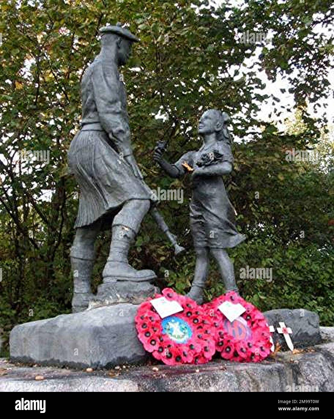 To British eyes this is probably the most beautiful traditional war memorial in Holland. It is a statue of a kilted Highlander looking down on a delightful young Dutch girl. The attitude and facial expression of the figures tells all there is to say about the Liberation: the happy trusting face of the girl, the dependable, strong yet gentle face of the soldier. It is reminiscent of the Highlander at the head of 'Y' Ravine at Beaumont Hamel on the Somme. The legend on the Memorial describes how on the 23rd October 1944 the 51st Highland Division launched an offensive from this position that c Stock Photo