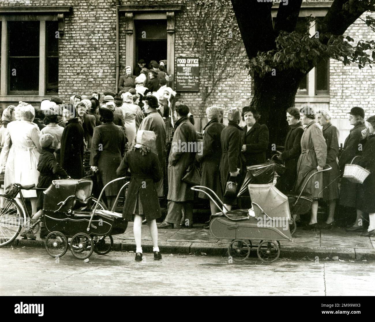 Women queuing outside a Food Office for ration books at the beginning of the Second World War. Stock Photo