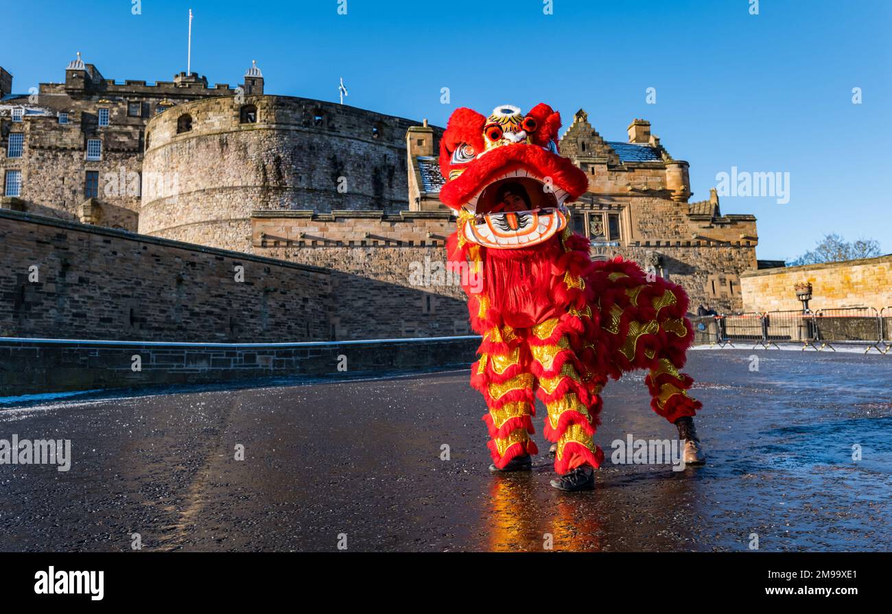 Chinese dragon dancers celebrate Chinese New Year at Edinburgh Castle on a sunny Winter day, Scotland, UK Stock Photo