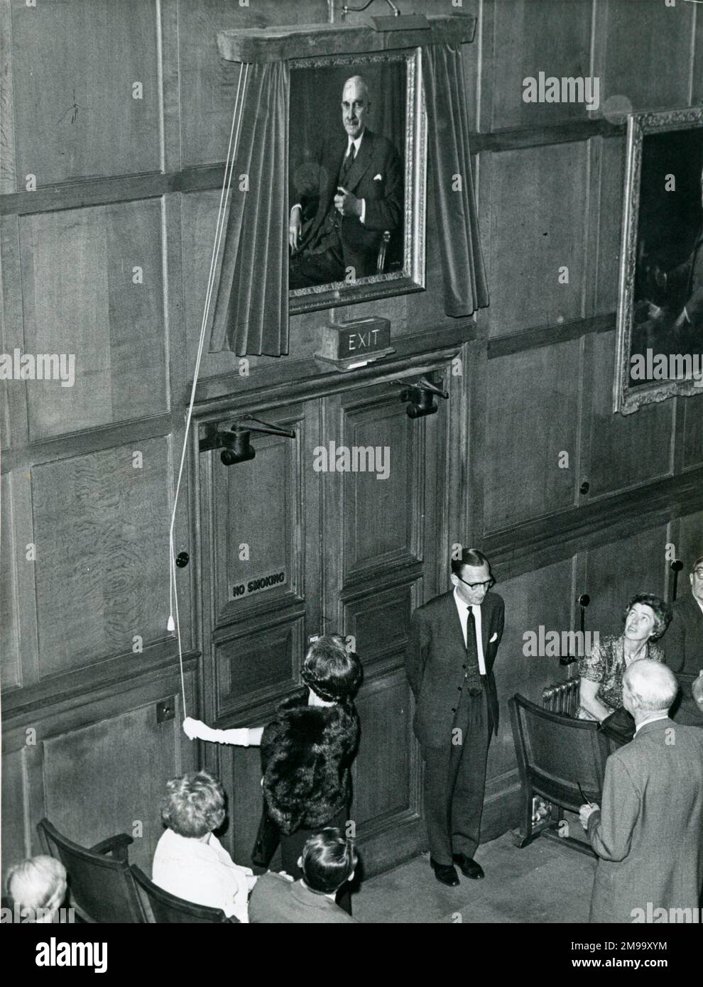 Miss Stanier unveiling Sir William Stanier's portrait at IMechE, during meeting 6 Oct 1966. Watched by Lord christopher Hinton [bottom right, back to camera]. Stock Photo
