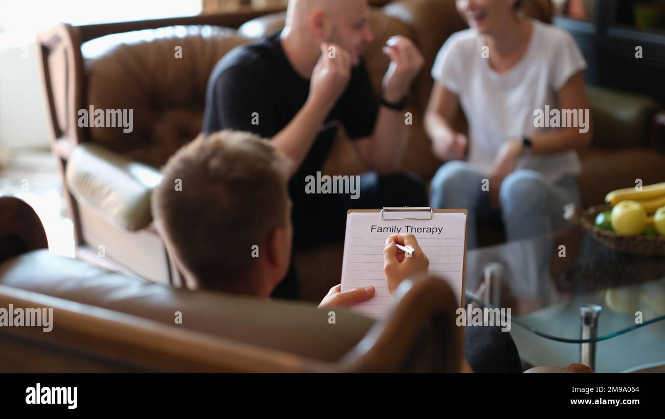 Family therapy session, couple solving family relationship problems with psychologist in doctor's office. Stock Photo