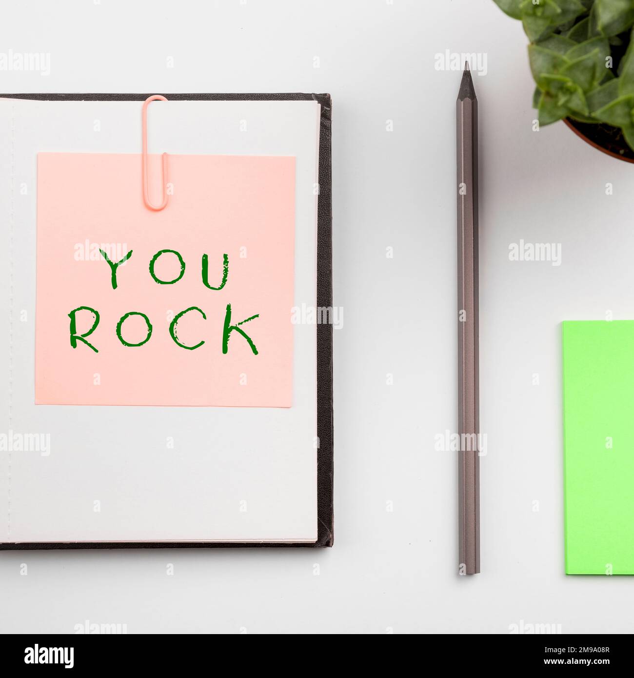 Hand writing sign You Rock, Concept meaning slang phrase of praise or