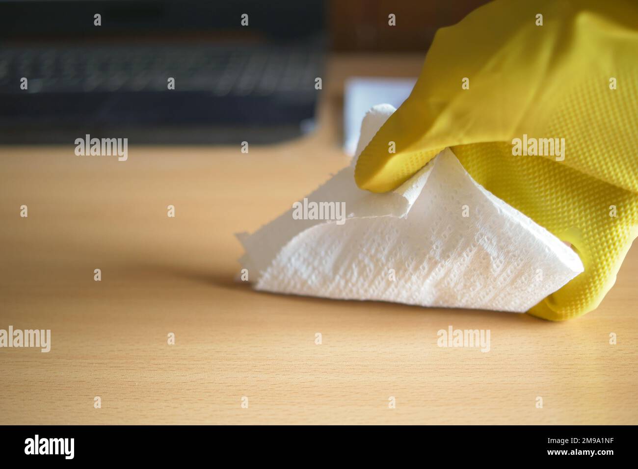 hand in blue rubber gloves cleaning table with cloth Stock Photo - Alamy
