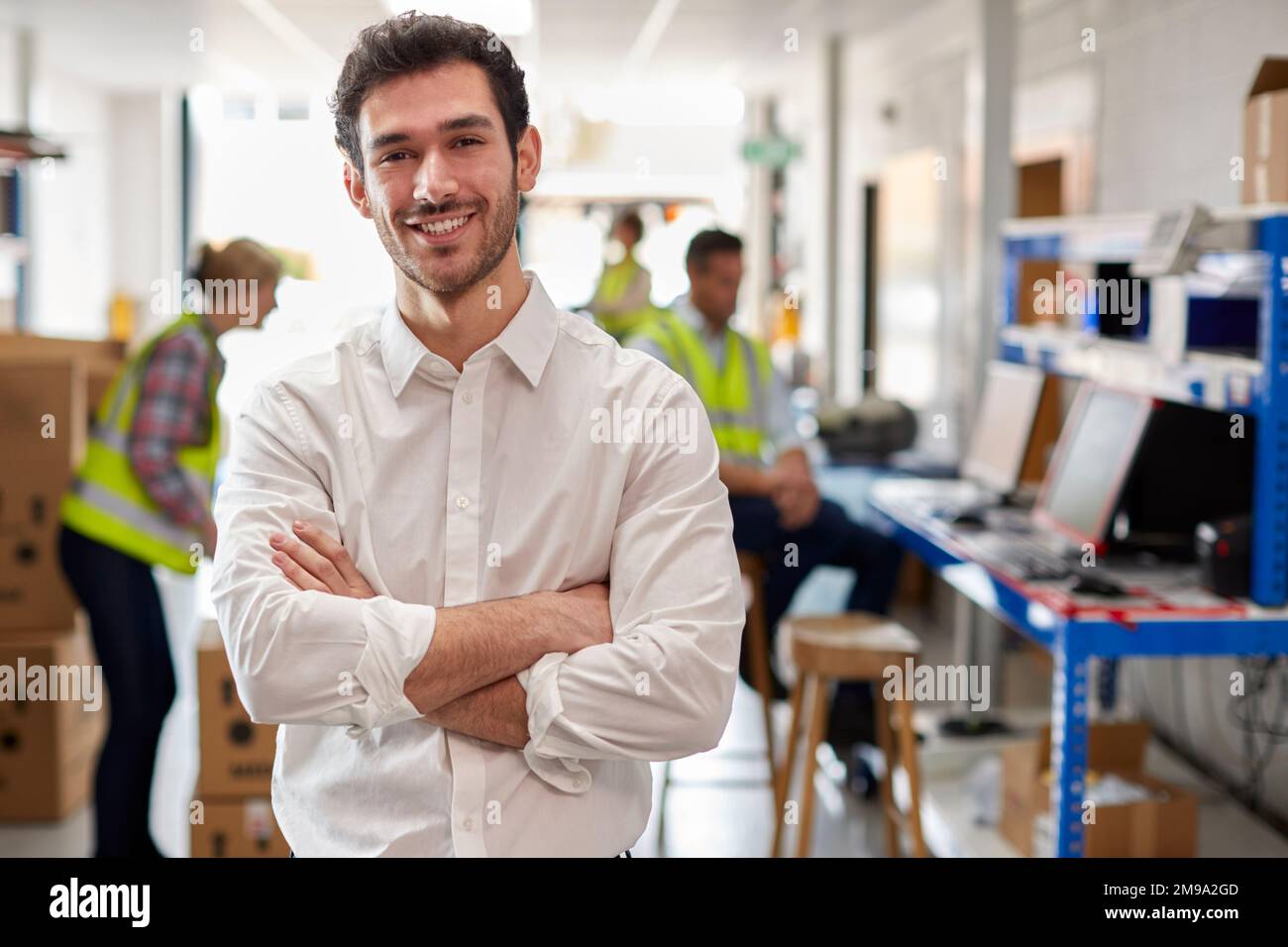 Portrait Of Male Manager In Logistics Distribution Warehouse Stock Photo