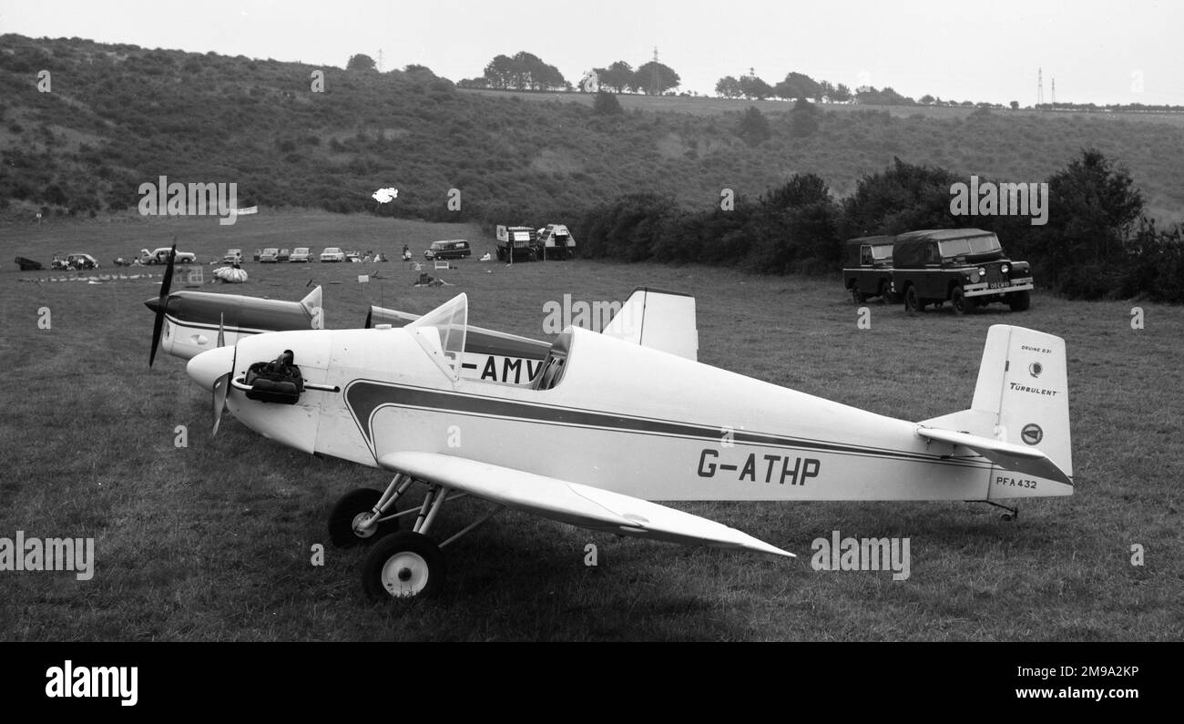 Druine D.31 Turbulent G-AthP with Tipsy Junior G-AMVP at a balloon meet somewhere in the UK, possibly at Dunstable. (a packed balloon in the background and trailers with gas bottles suggest that it is a gas balloon meet rather than for hot-air balloons). Stock Photo