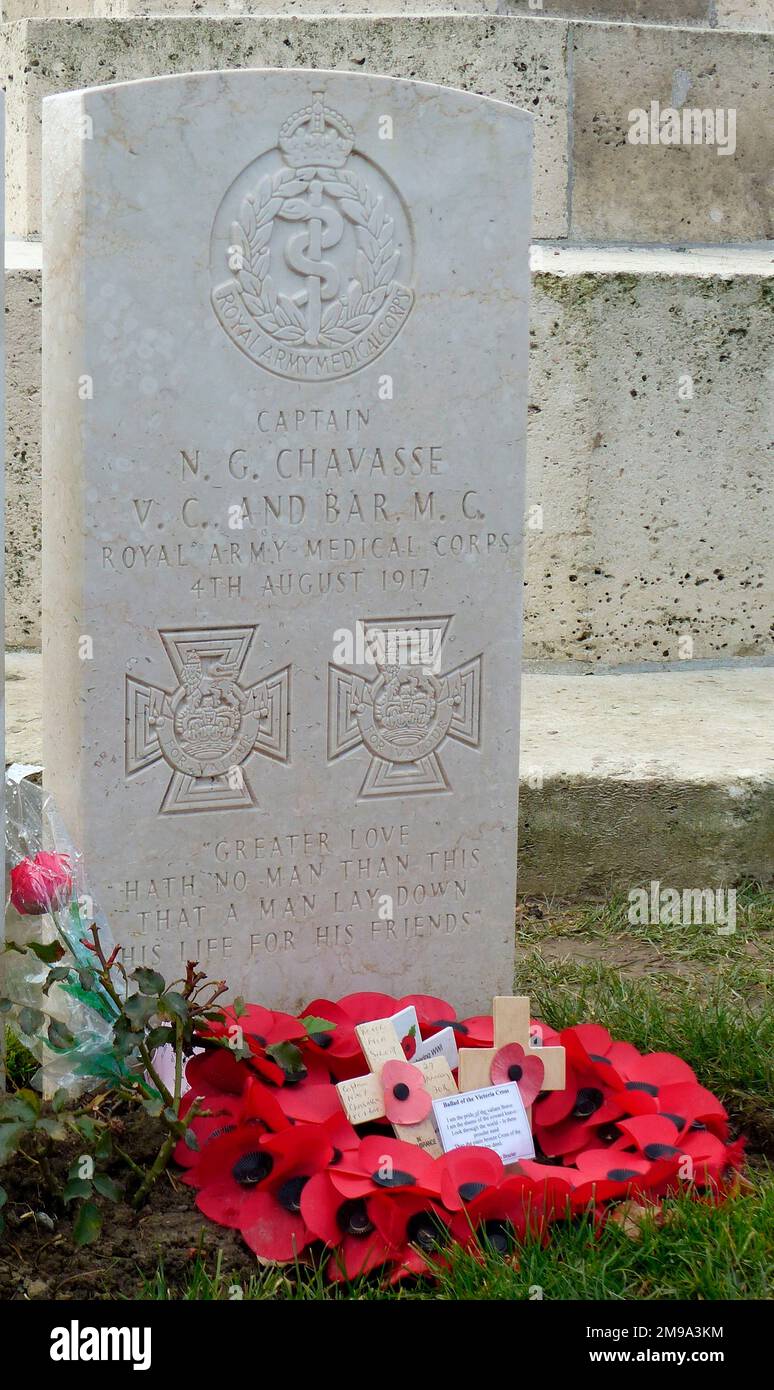 Chavasse is buried in Brandhoek New Military Cemetery and his headstone shows two emblems of the Victoria Cross. Doctor Chavasse, one of twin brothers, is the only person to win the VC twice in the First World War. His first citation was for tending wounded under fire on 9/10 August 1916 on the Somme and his second  for similar actions over a period until he was wounded on 2 August 1917 near Wieltje. He died on 4 August 1917. Stock Photo