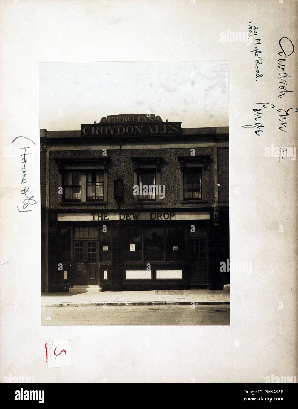 Photograph of Dew Drop PH, Penge, London. The main side of the print (shown here) depicts: Face on view of the pub.  The back of the print (available on request) details: Trading Record 1934. 1961 for the Dew Drop, Penge, London SE20 8HU. As of July 2018 . Part (201.203) converted to clothes shop and part (205) to carpet shop. Clothes shop since converted to 'Loafe' cafe in December 2012, renamed 'Blue Mountain Cafe' by November 2013. Carpet shop empty 2014. Stock Photo