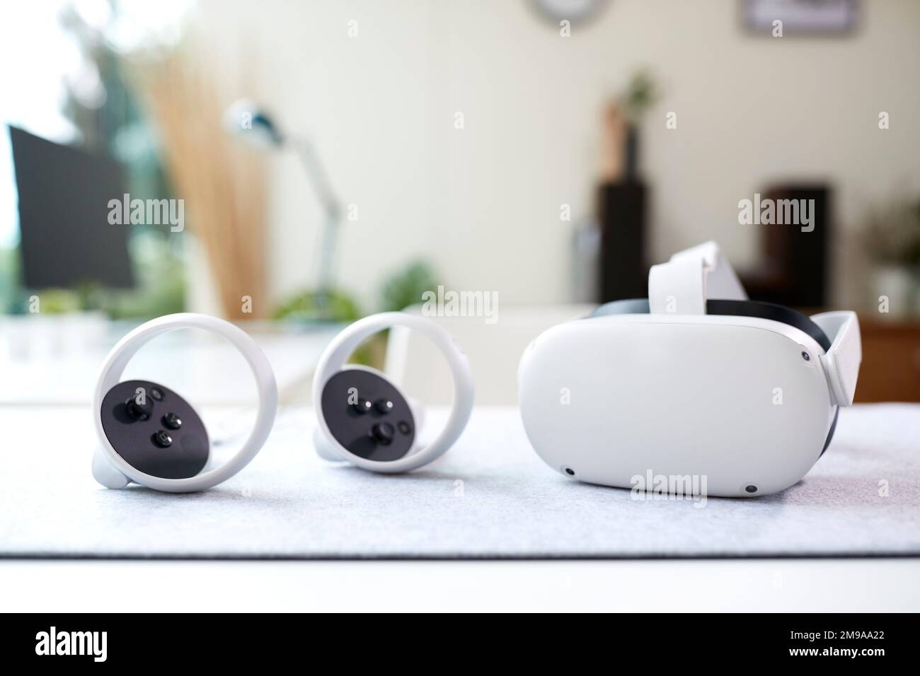 VR Headset And Gaming Controllers On Table At Home Stock Photo