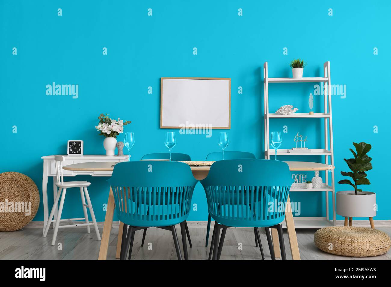 Interior of stylish dining room with big table, blue chairs and wall ...