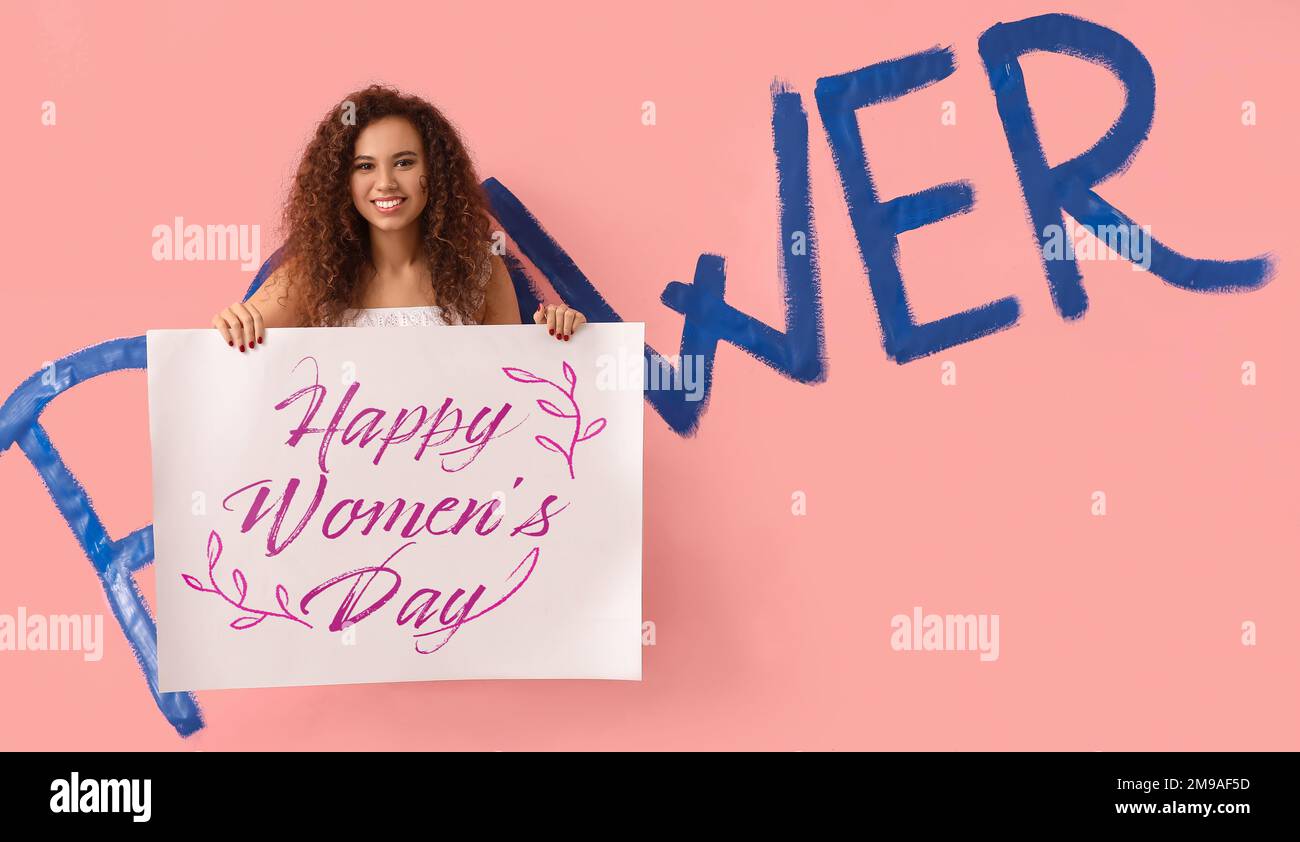 Young African-American girl with poster for International Women’s Day …