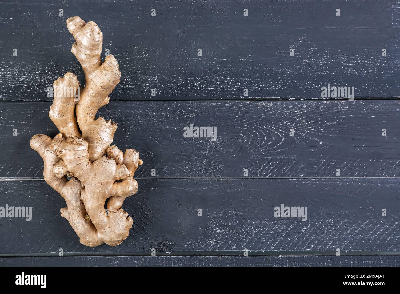 Fresh ginger roots on dark wooden background Stock Photo