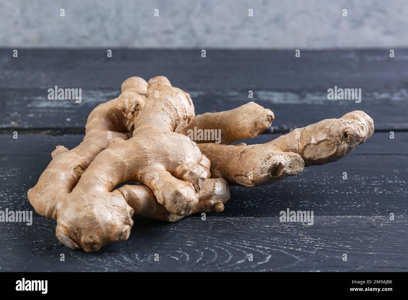 Fresh ginger roots on dark wooden table Stock Photo