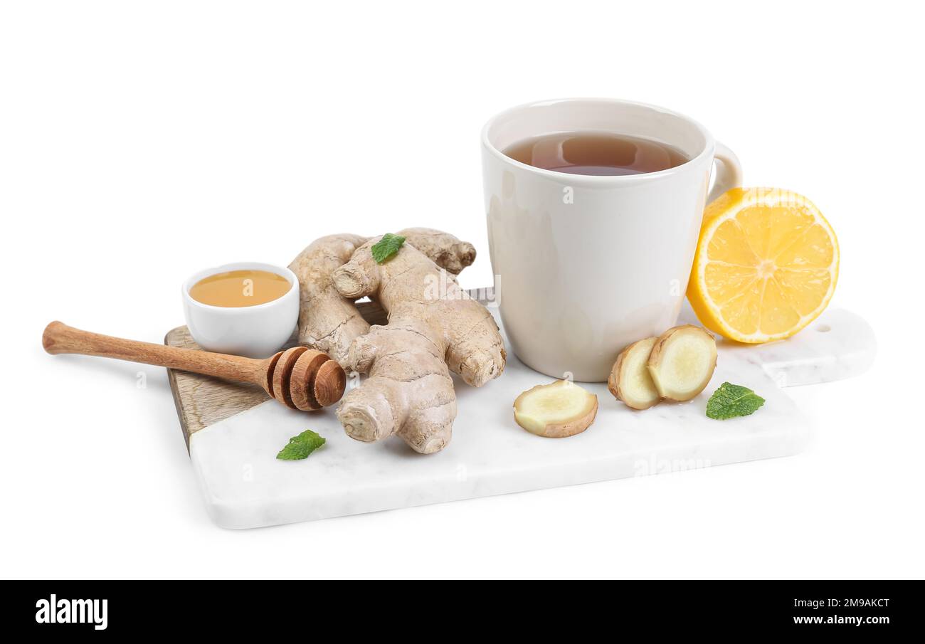 Board with ginger root, cup of black tea, honey and lemon isolated on