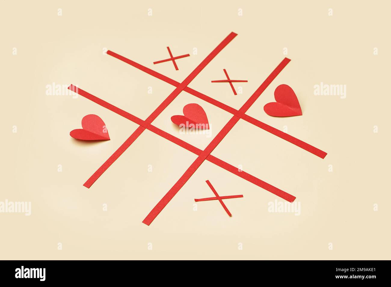 Tic tac toe game with paper hearts on color background. Valentines Day