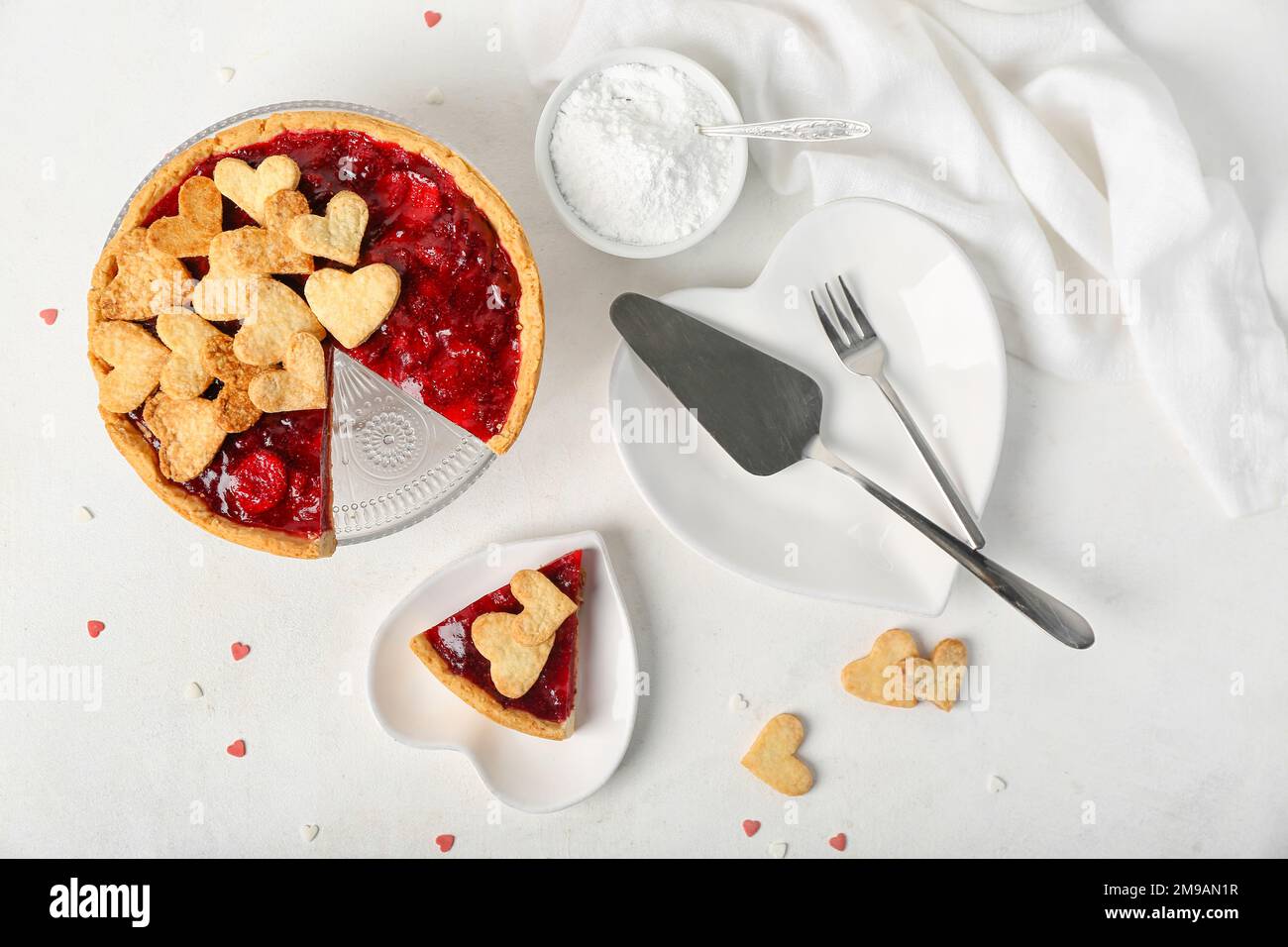 Stand and heartshaped plates with sweet strawberry pie and cookie hearts for Valentine's day on