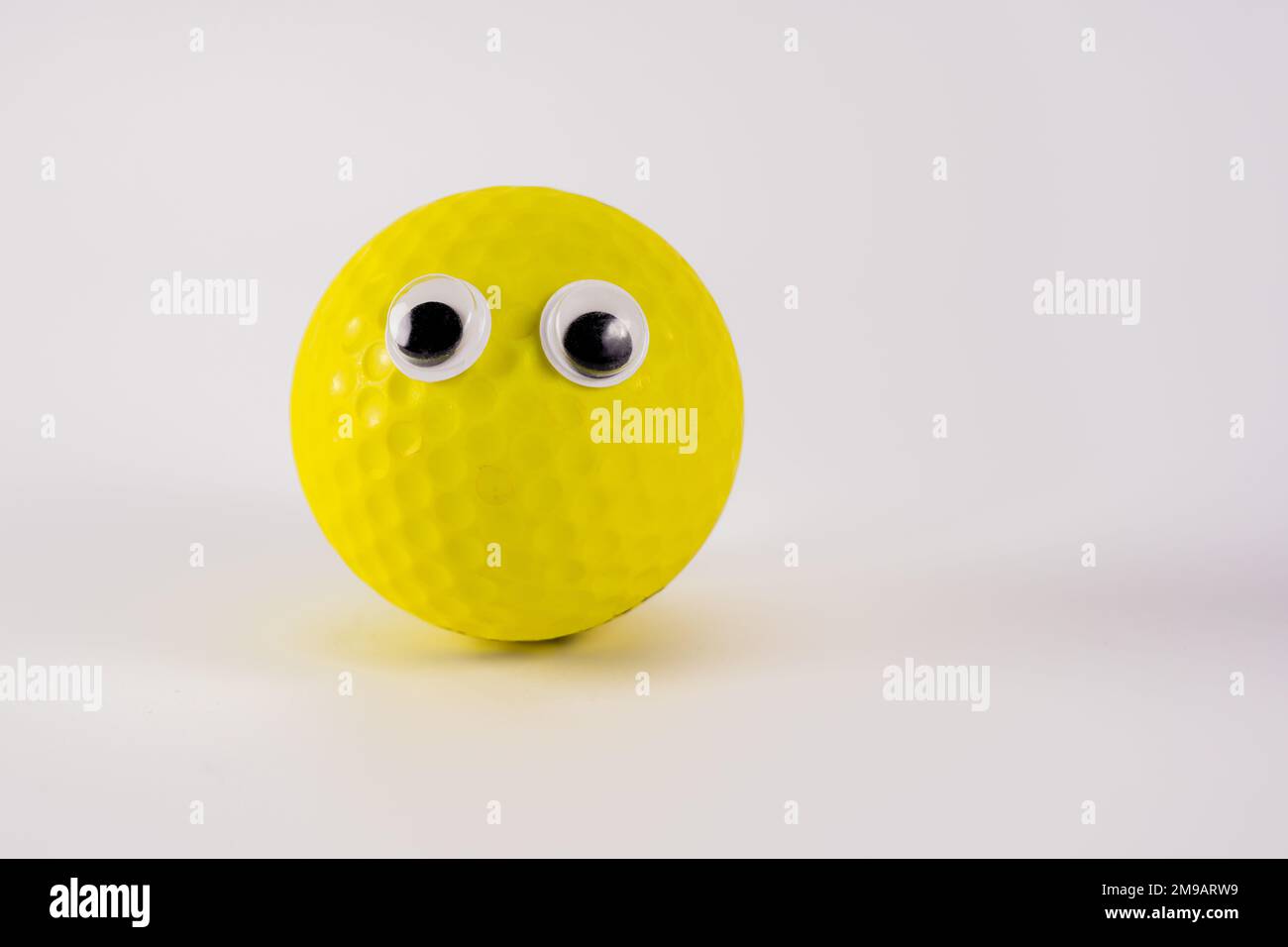 funny yellow ball character with googly eyes isolated on a white background Stock Photo