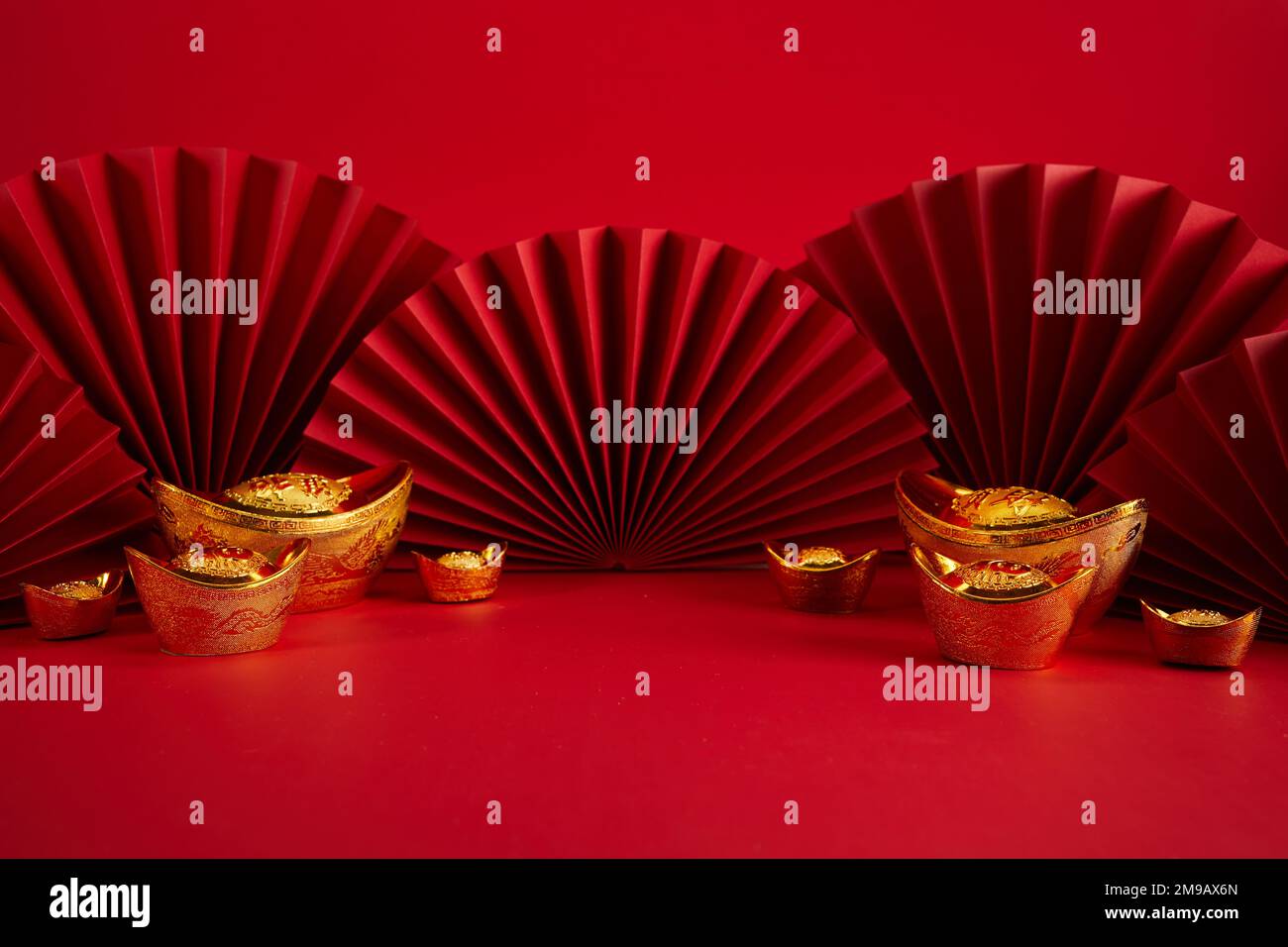 Chinese New Year product display background with ingot and paper fan. Translation Let ten