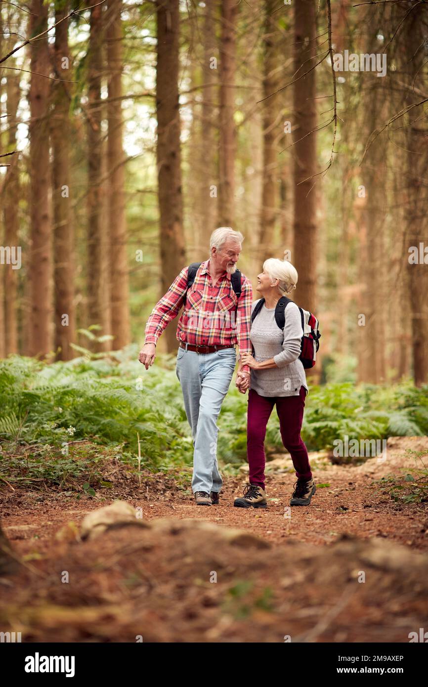 Loving Retired Senior Couple Hiking In Woodland Countryside Together Stock Photo