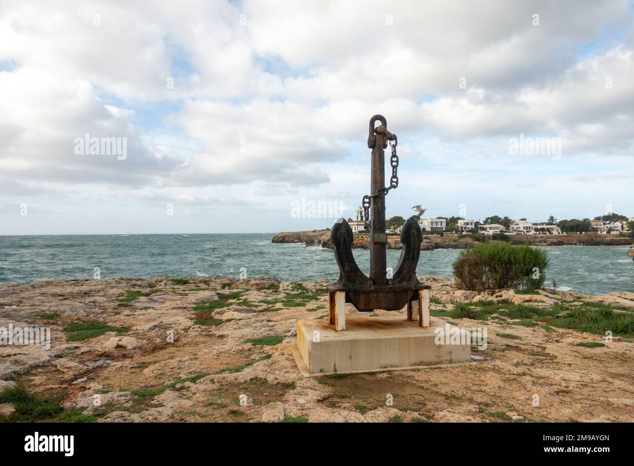 Ciutadella Spain. Entrance of  harbour with anchor statue of Ciutadella, Menorca, Balearic Islands, Spain Stock Photo