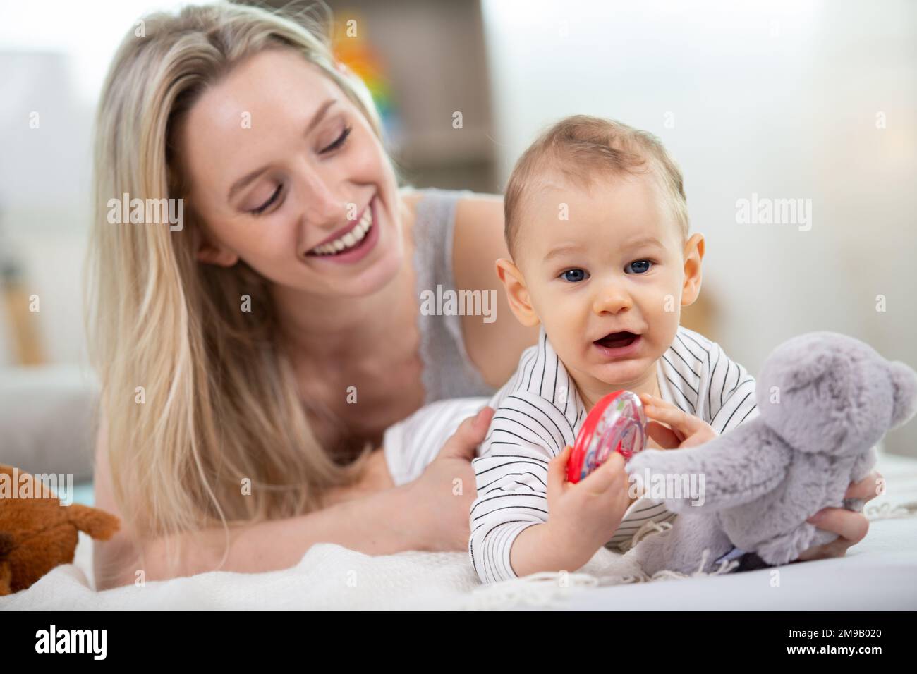cute baby and mother sitting on floor at home Stock Photo - Alamy