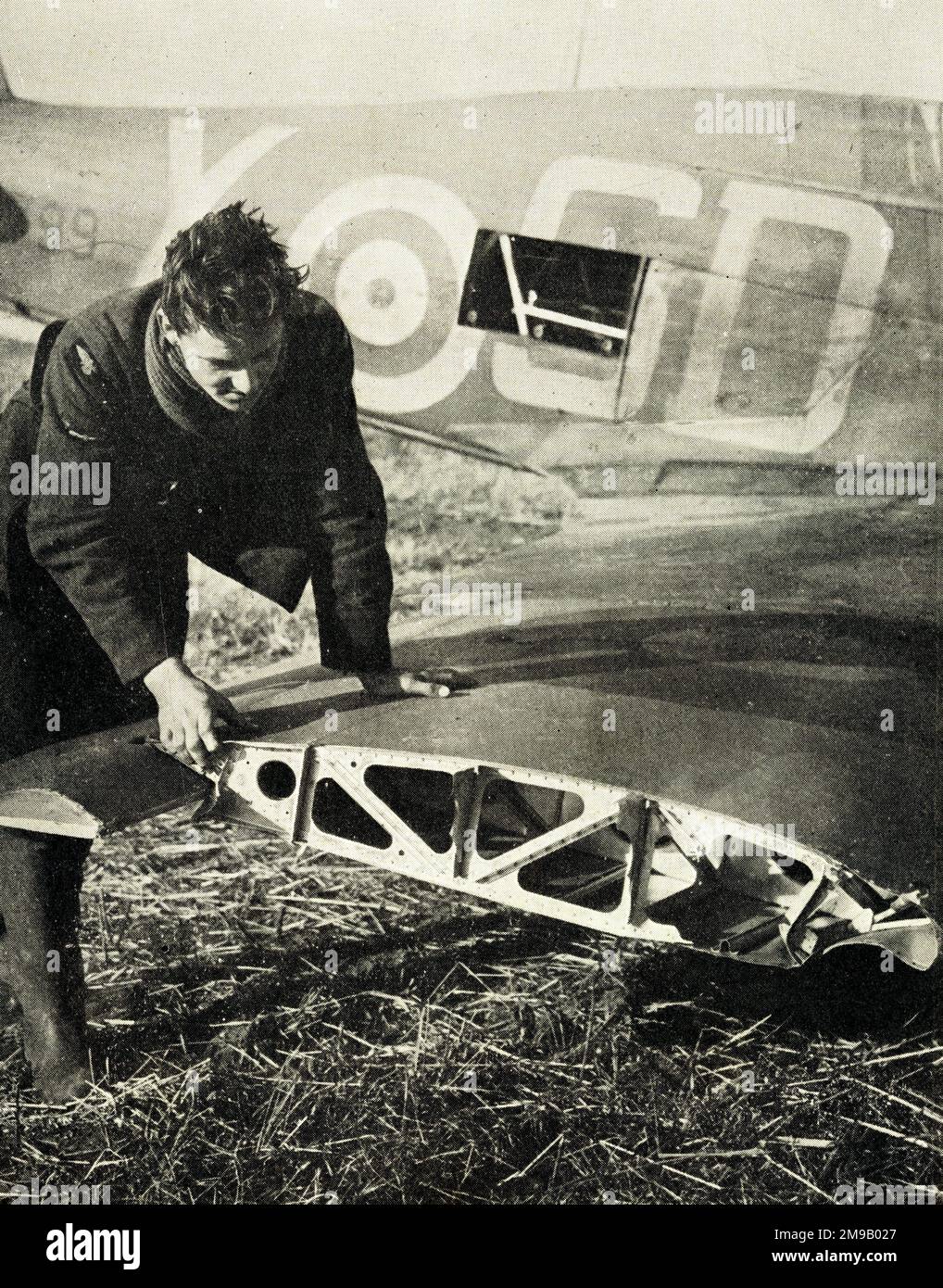 Royal Air Force Pilot Officer K.W. MacKenzie, DFC, inspecting wing of his Hurricane, WW2. Stock Photo