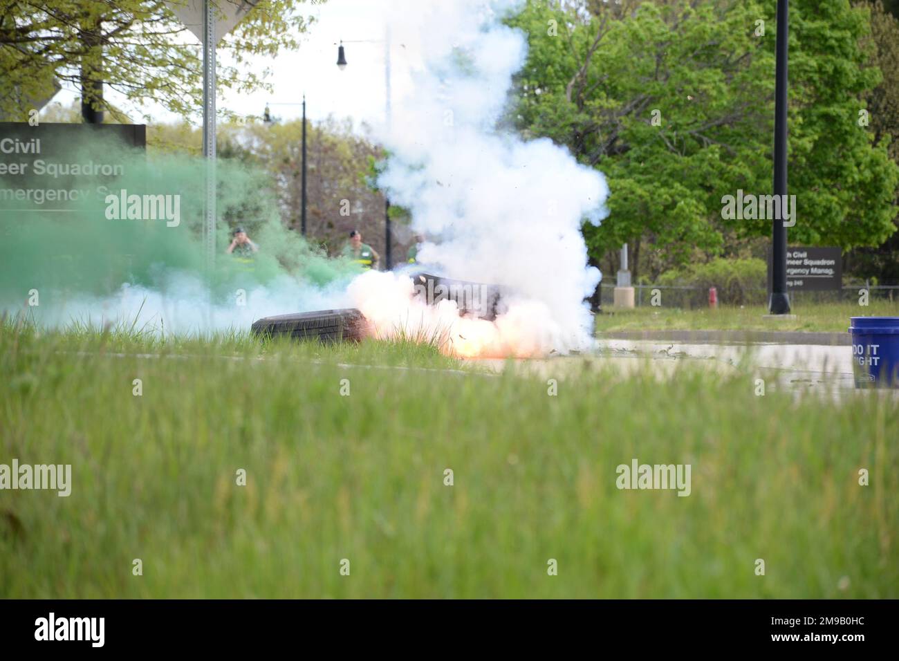 A group of Airmen look on as an M115A2 ground burst simulator explodes as part of a multi-day military readiness exercise at Pease Air National Guard Base, Newington, N.H., May 15. The exercise, which ran May 12-15, tested the wing's ability to deploy and operate in a contested environment. Stock Photo