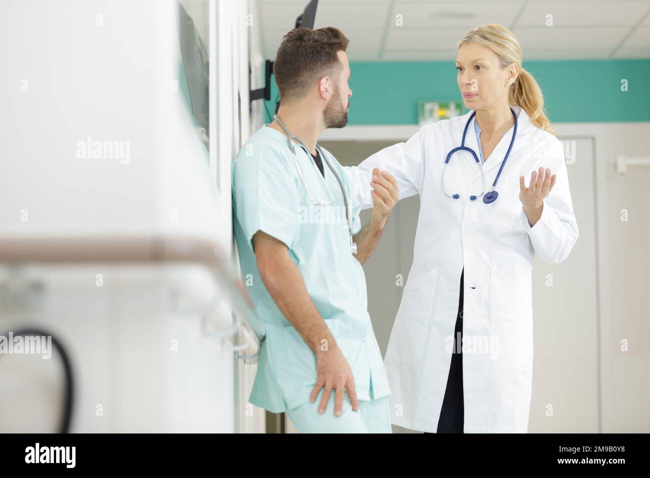 medical staff having discussion in a hospital hallway Stock Photo - Alamy