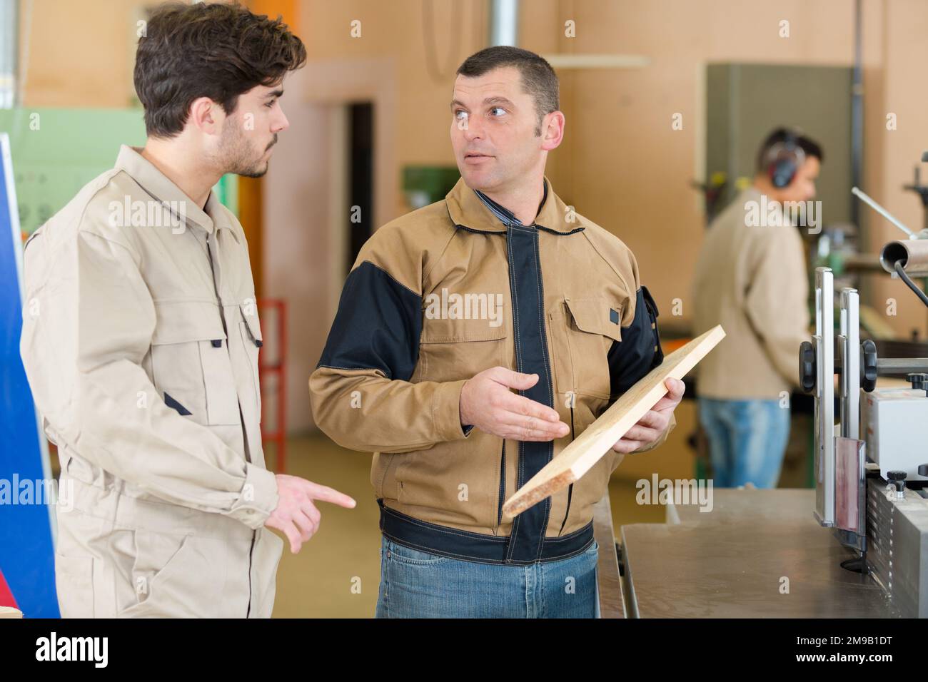 carpenter with apprentice in training period Stock Photo - Alamy