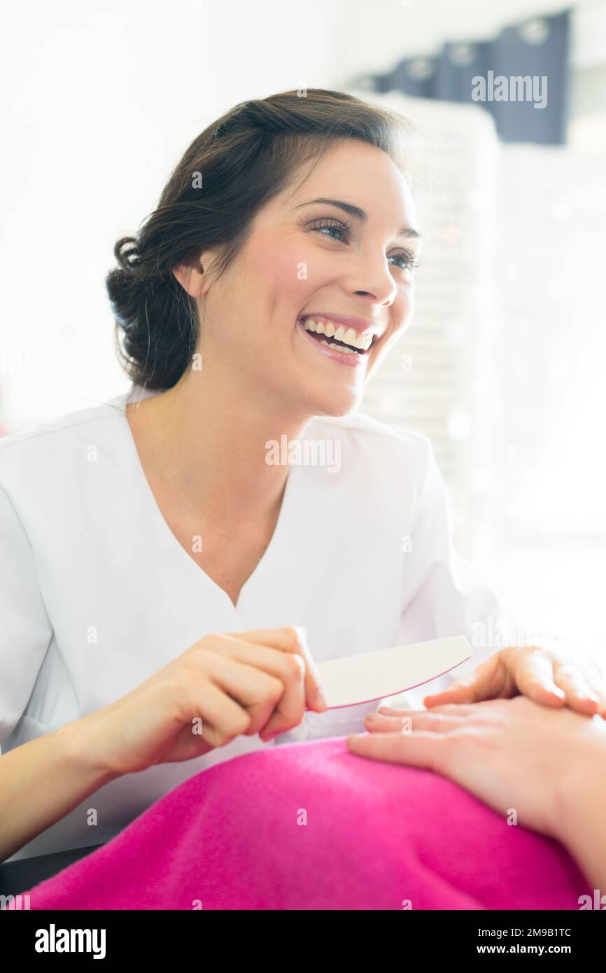 woman getting a manicure at a nail salon Stock Photo Alamy