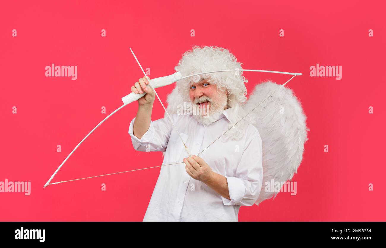Happy Valentines Day. God of Love. Funny angel cupid aiming with bow and arrow. Symbol of love. Stock Photo