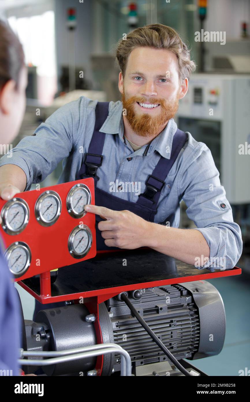man showing compressor safety dials Stock Photo Alamy