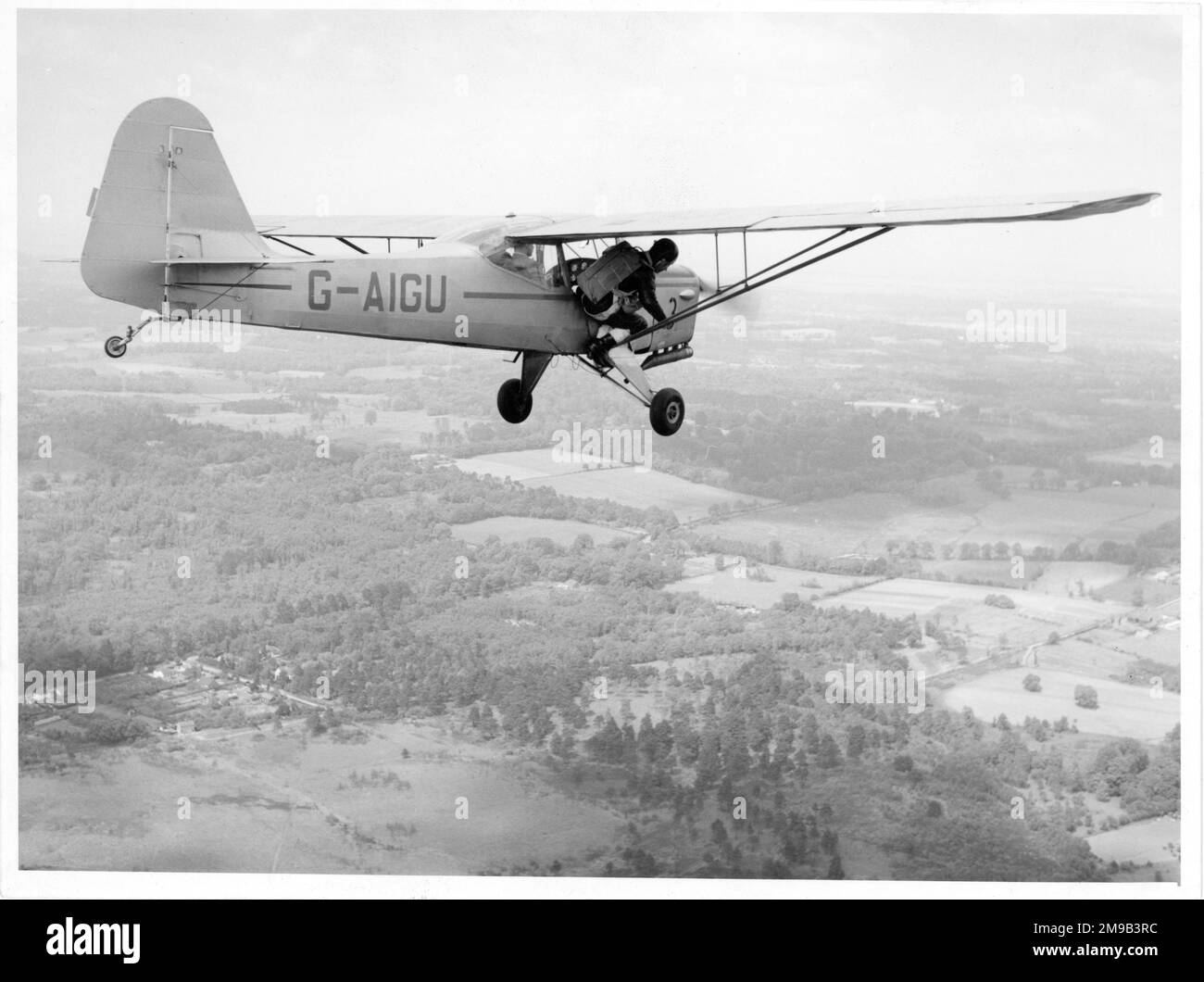 A parachutist preparing to jump from Auster J-1N Alpha G-AIGU (msn 2180), for a television programme hosted by Raymond Baxter. Stock Photo