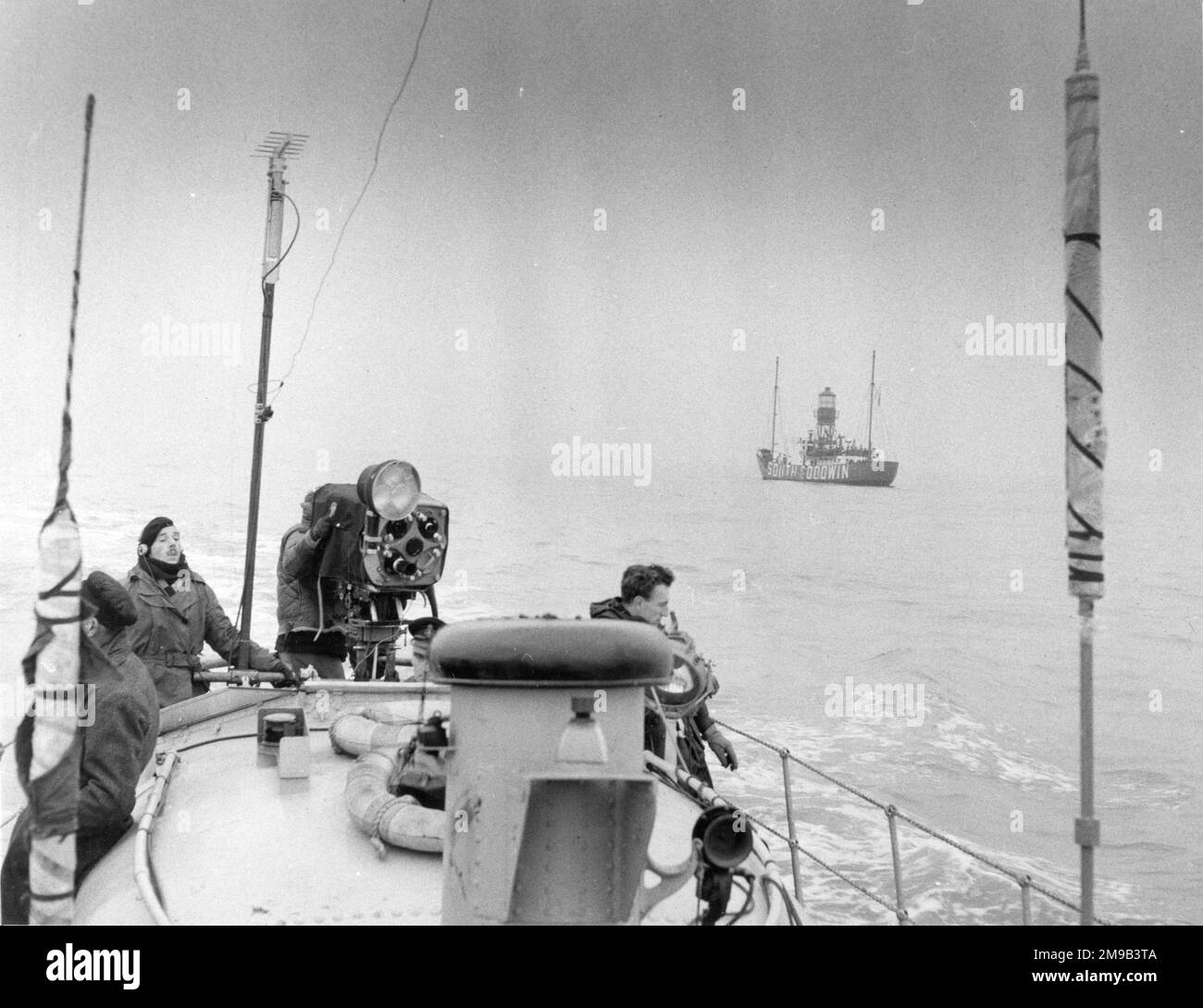 Raymond Baxter filming at sea, on 'location', aboard a launch near the South Goodwin Lightship. Stock Photo