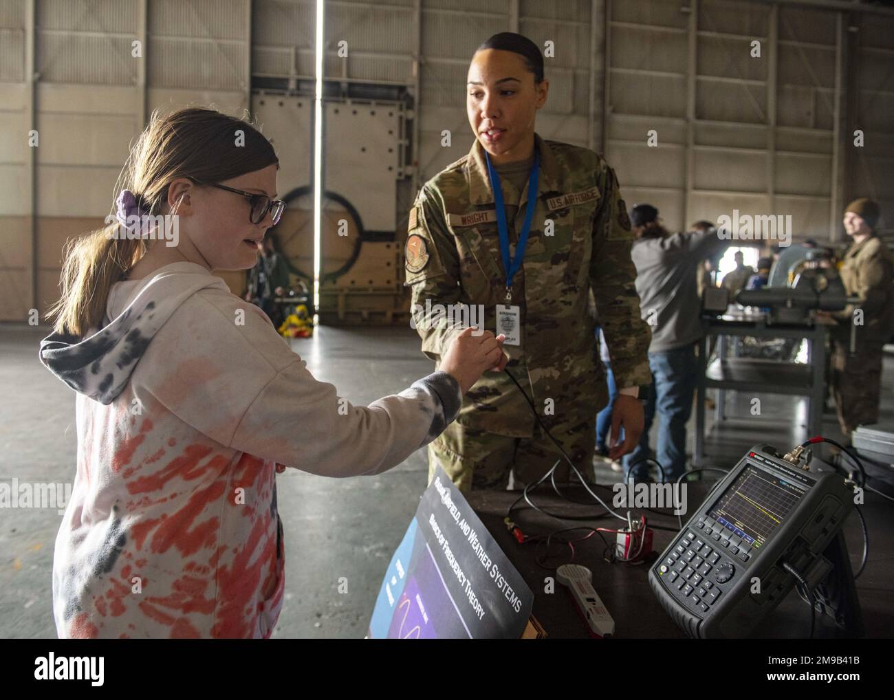 A U.S. Air Force Airman showcases communication equipment to an airshow