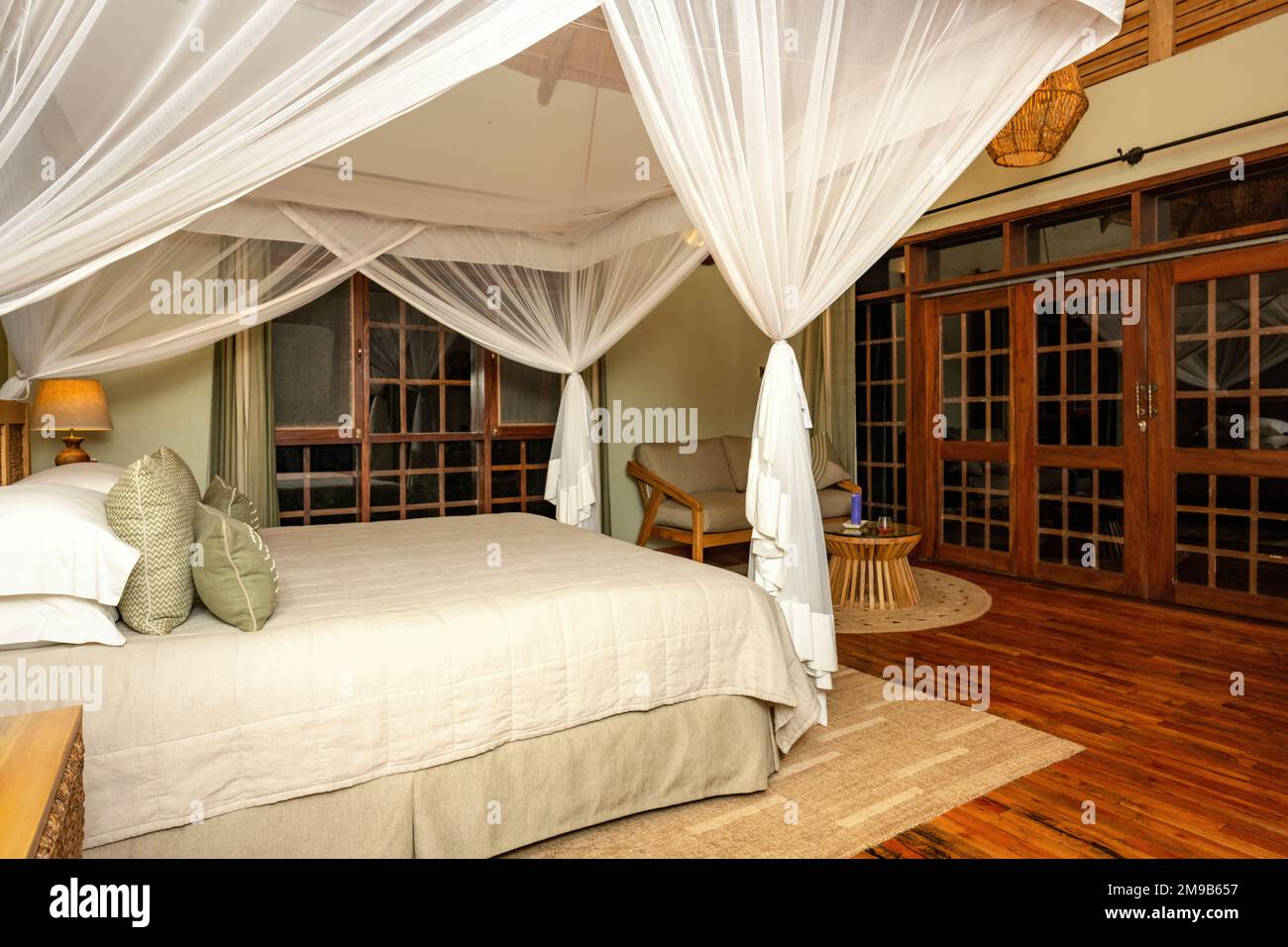 The main bedroom area of the cottage accommodation at Primate Lodge, Kibale National Park, Uganda. Stock Photo