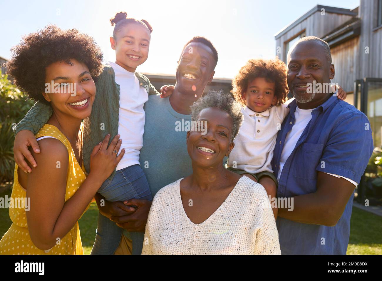 Portrait Of Multi-Generation Family Outdoors In Garden At Home Stock Photo