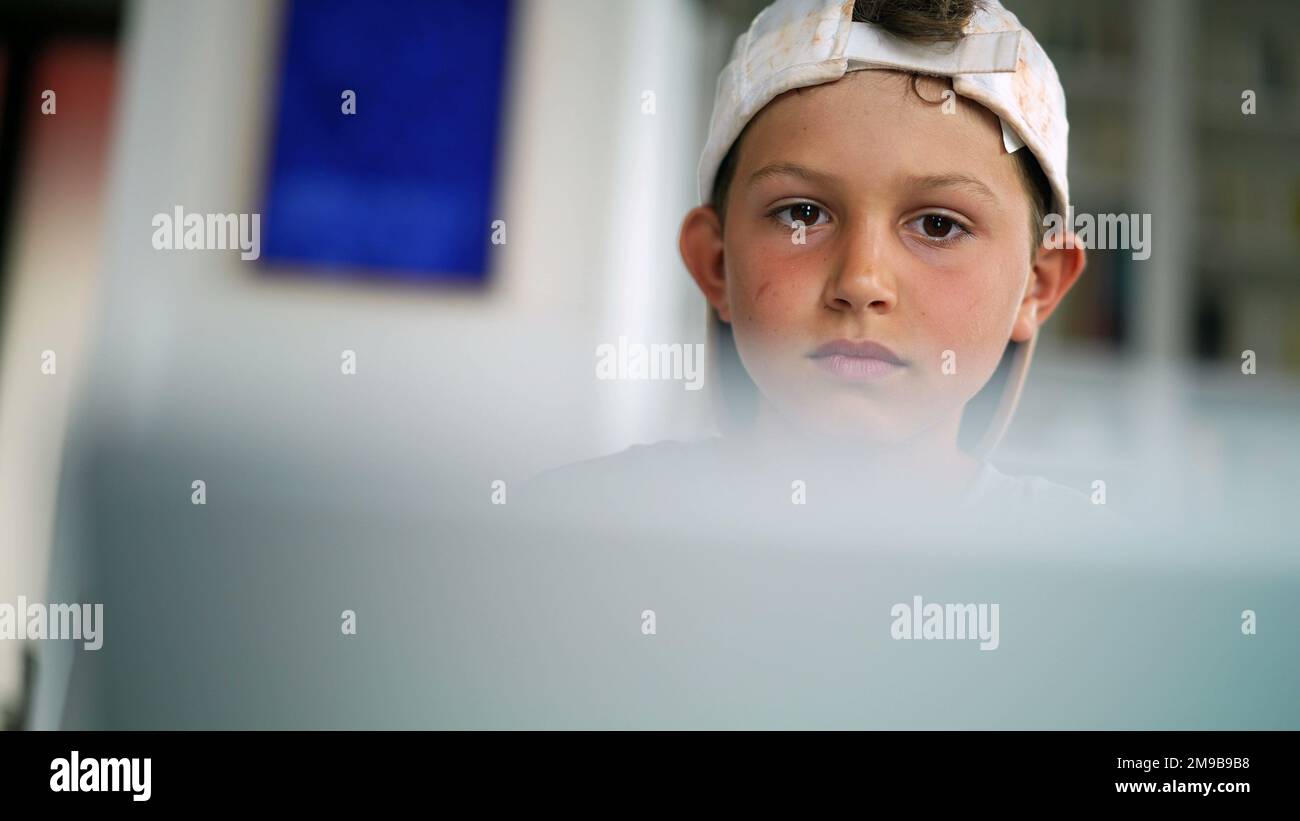 Young boy watching movie, close-up kid face staring at entertainment Stock Photo