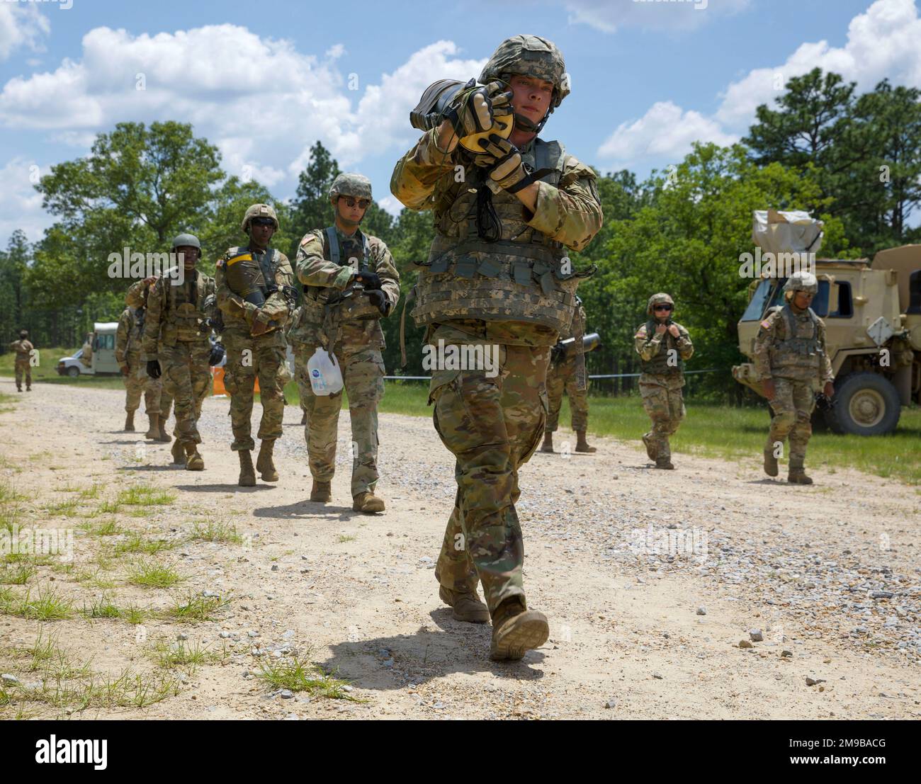 Soldiers with the 61st Troop Command carry explosives to the demolition site in Camp Shelby, Mississippi, May 15, 2022. Engineers conduct route clearance operations training to uncover improvised explosive devices in a controlled environment. Stock Photo