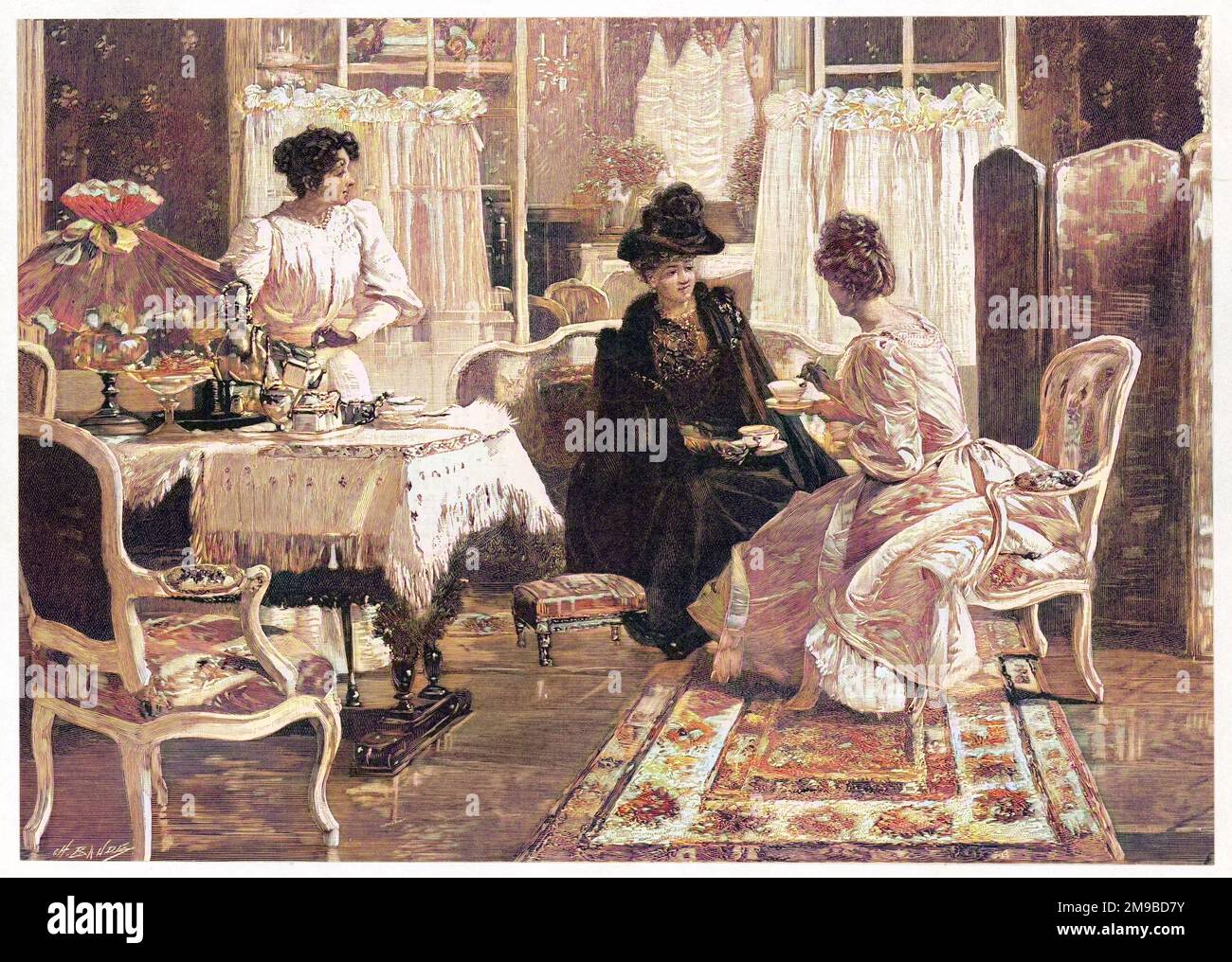 A lady entertains a visitor to afternoon tea in a lush interior. The maid stands ready to pour more tea or offer a plate of food. Stock Photo