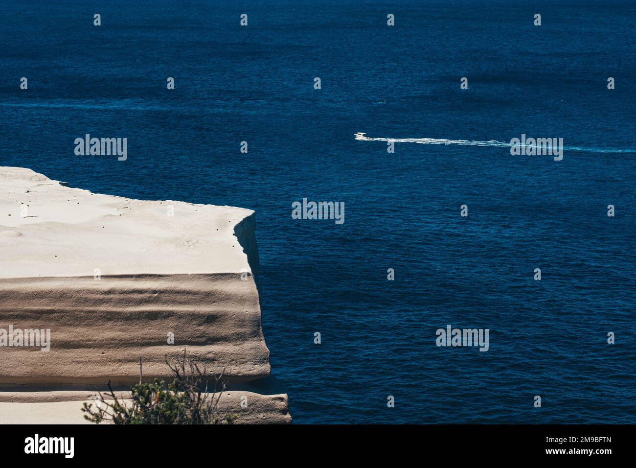 A scenic view of a a tranquil blue sea at the Wedding Cake Rock beach in Sydney on a summer day Stock Photo