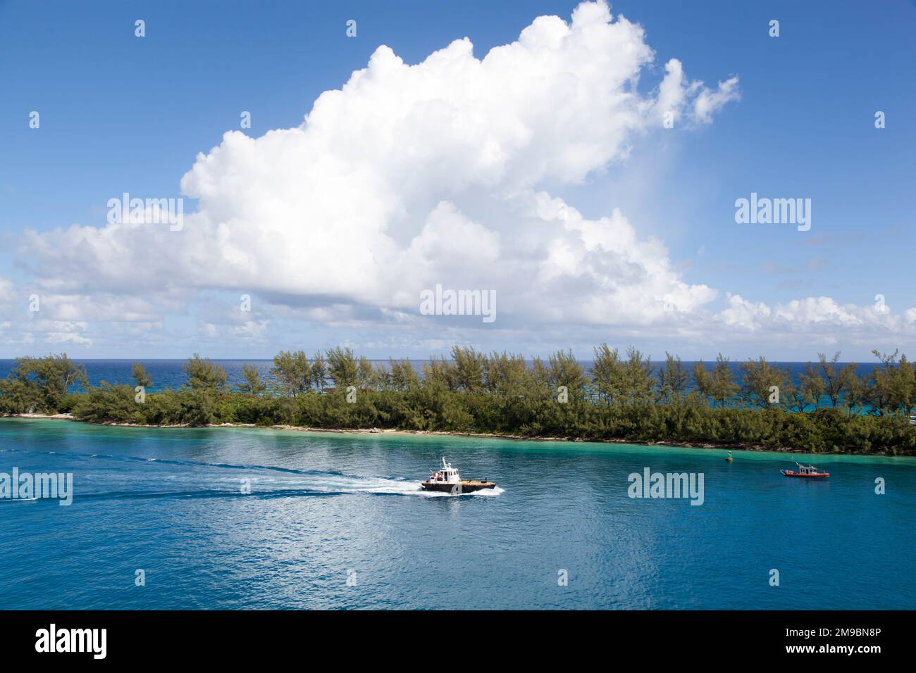 The aerial view of a boat passing by in Nassau Harbour and a narrow