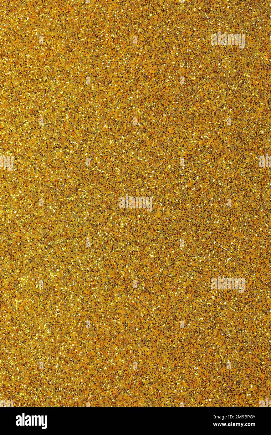 Golden wide shimmer background with reflective glitter material Stock