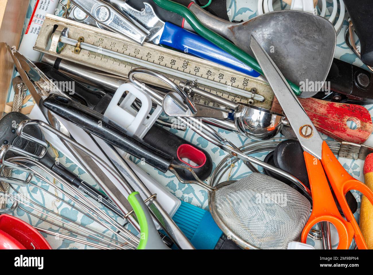 The contents of a kitchen junk drawer. Stock Photo